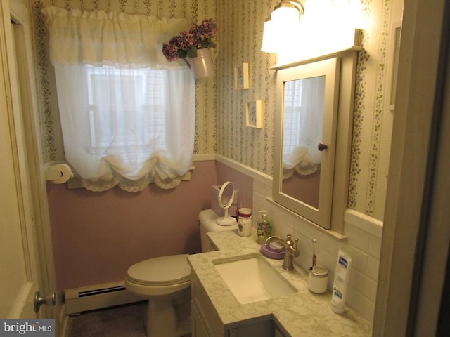 bathroom featuring baseboard heating, toilet, vanity, and tasteful backsplash