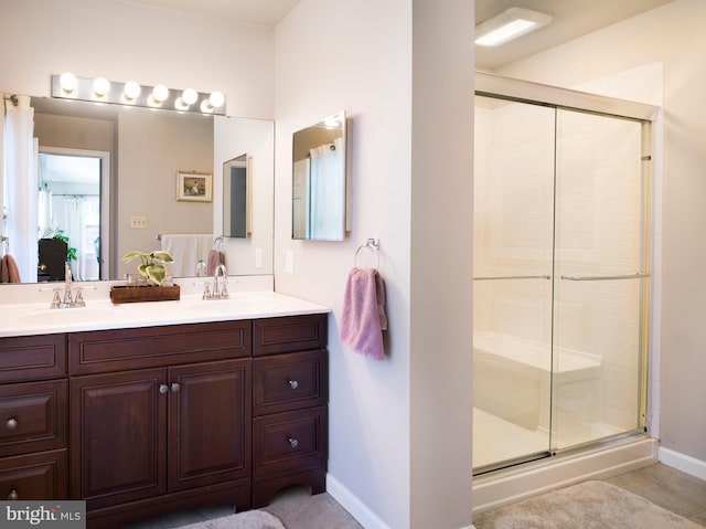 bathroom featuring vanity and an enclosed shower