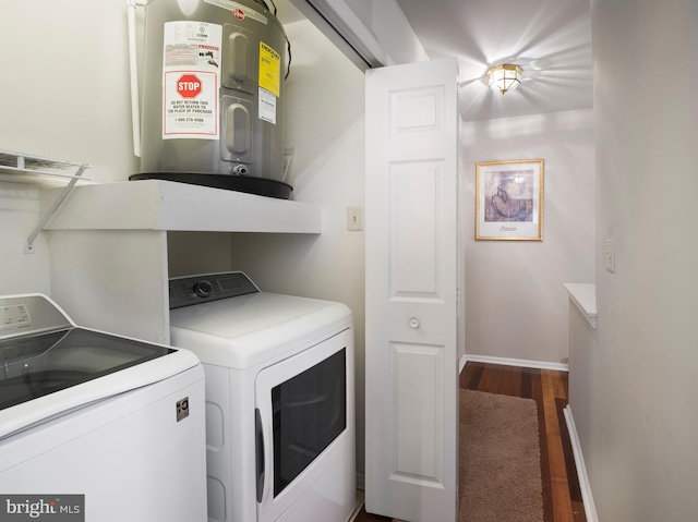 washroom featuring dark hardwood / wood-style floors, separate washer and dryer, and water heater