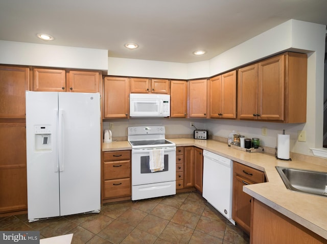 kitchen with white appliances and sink