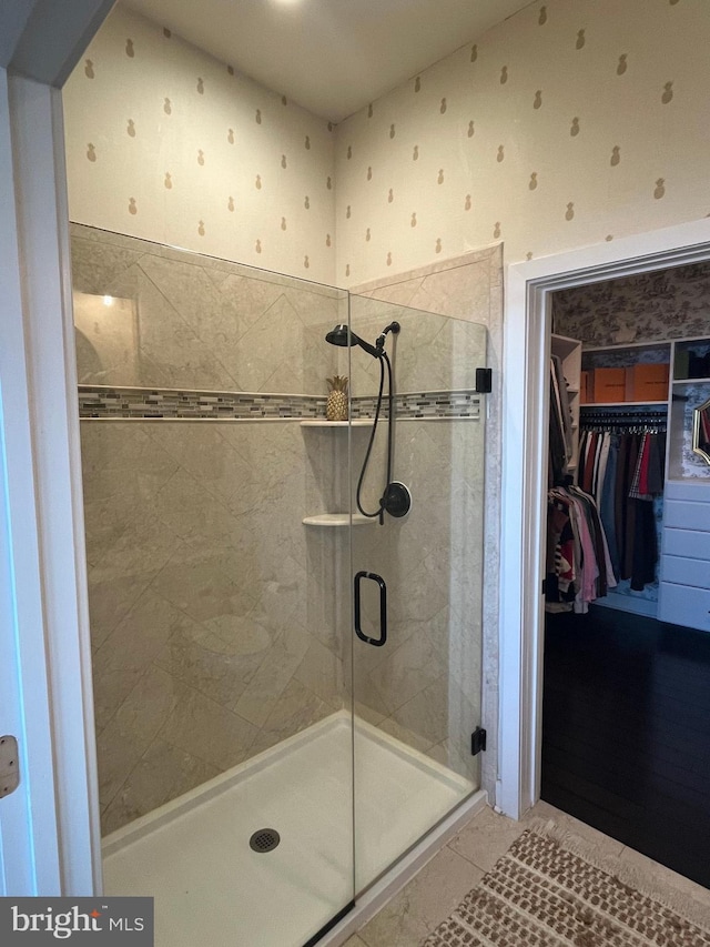 bathroom featuring tile patterned flooring and an enclosed shower