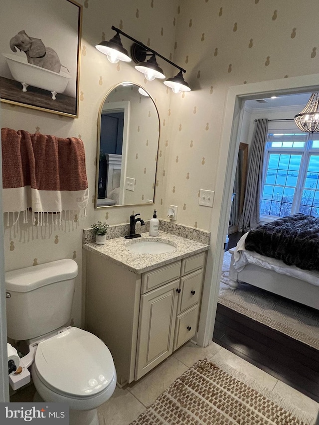 bathroom with tile patterned flooring, vanity, and toilet