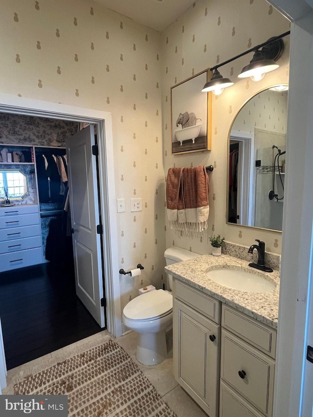 bathroom featuring tile patterned floors, vanity, and toilet