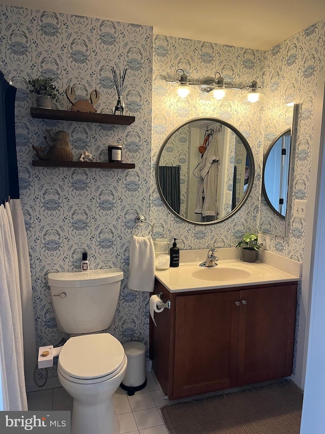 bathroom featuring tile patterned floors, vanity, and toilet