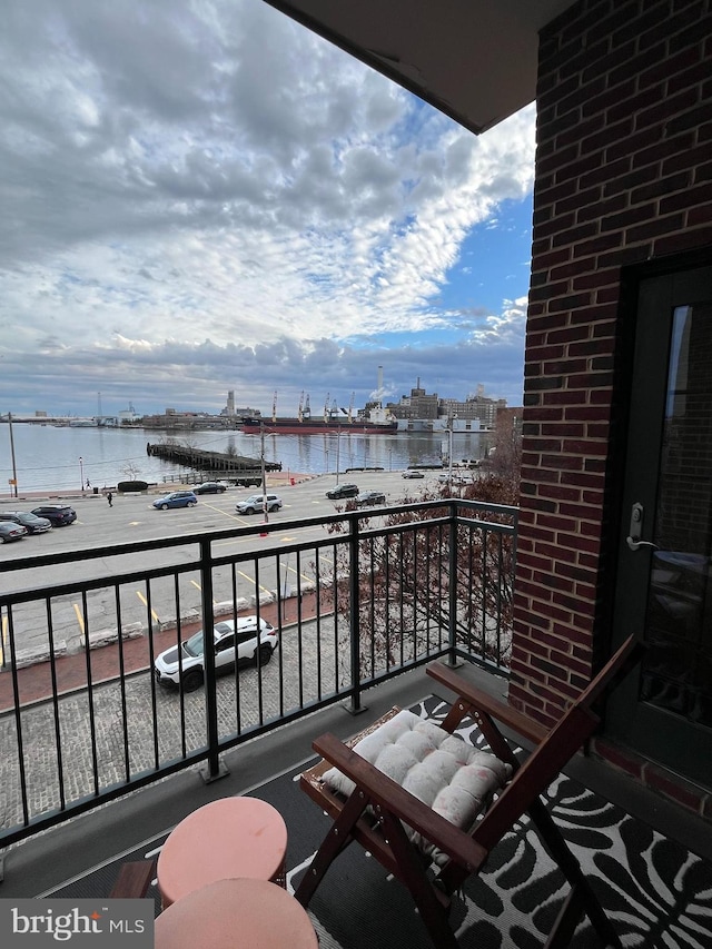 balcony featuring a water view