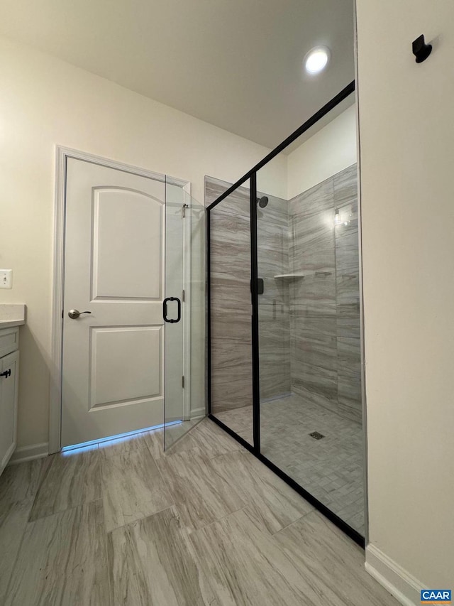 bathroom featuring vanity and a shower with shower door