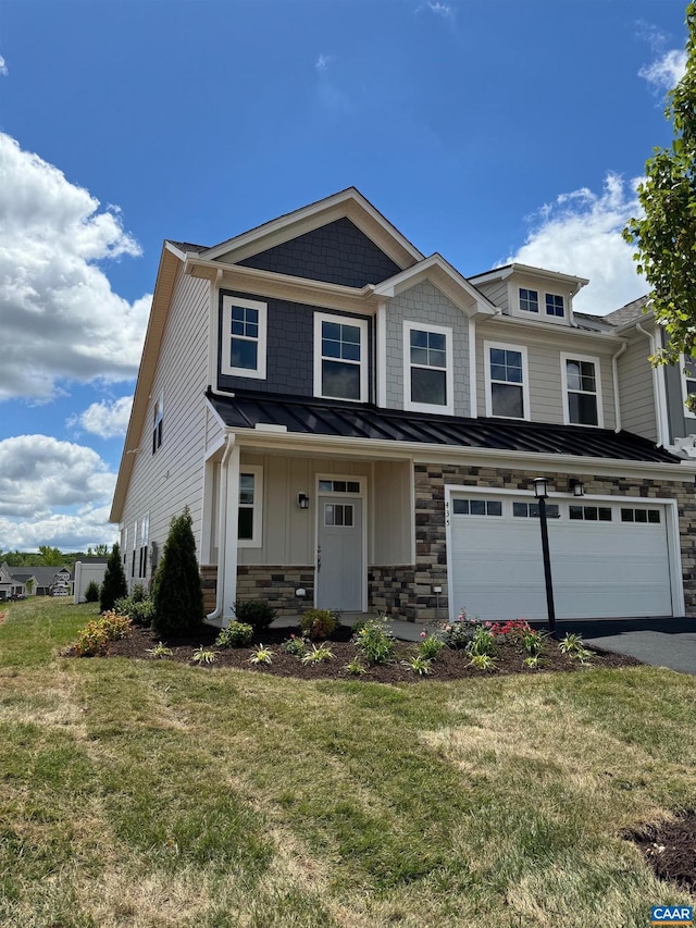 view of front of house with a front yard and a garage