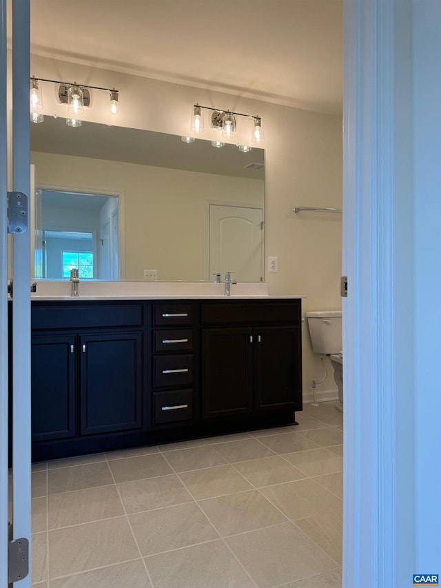 bathroom featuring tile patterned floors, vanity, and toilet