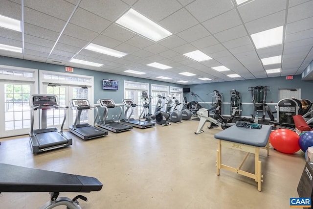 exercise room featuring a drop ceiling and french doors