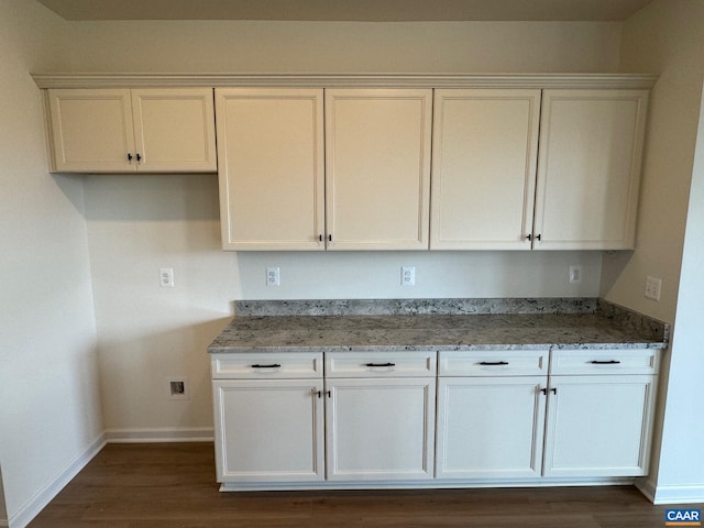 kitchen with stone counters and white cabinets