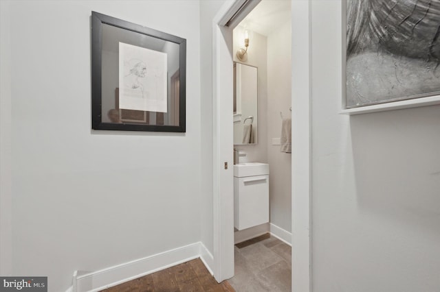 hall featuring dark hardwood / wood-style flooring and sink