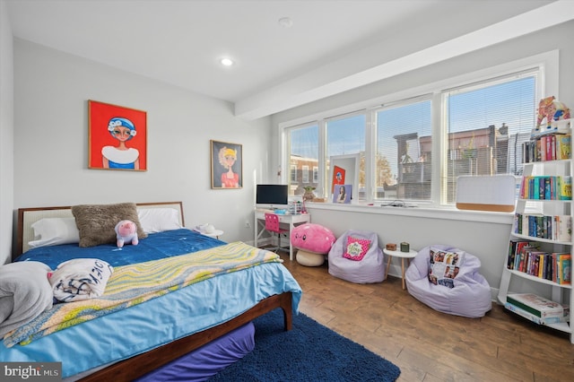 bedroom with hardwood / wood-style floors and multiple windows