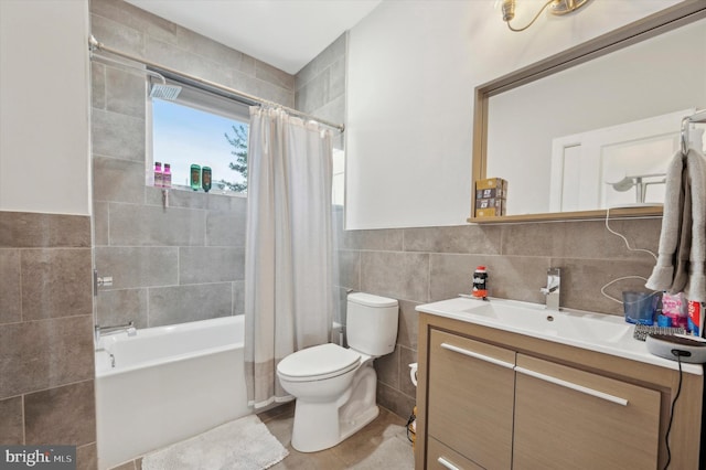 full bathroom with shower / bath combo, tile patterned floors, toilet, vanity, and tile walls