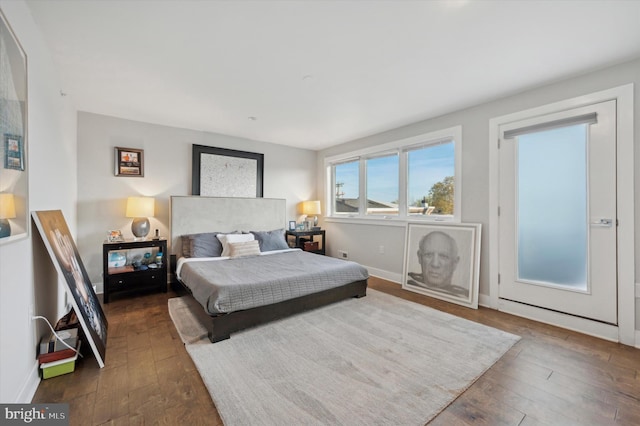 bedroom with dark hardwood / wood-style flooring