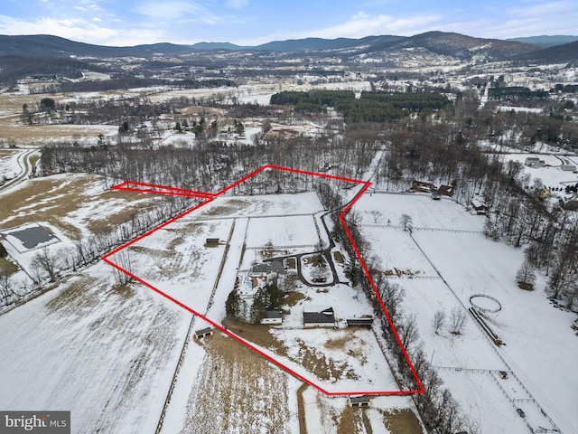 snowy aerial view with a mountain view