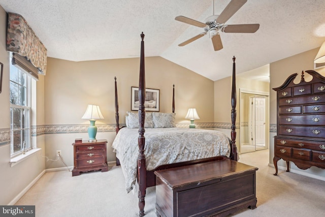 carpeted bedroom featuring a textured ceiling, ceiling fan, a closet, and vaulted ceiling