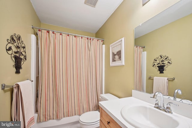 full bathroom featuring shower / bath combo with shower curtain, vanity, and toilet