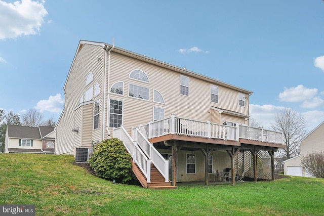 rear view of house with a yard, central air condition unit, and a wooden deck