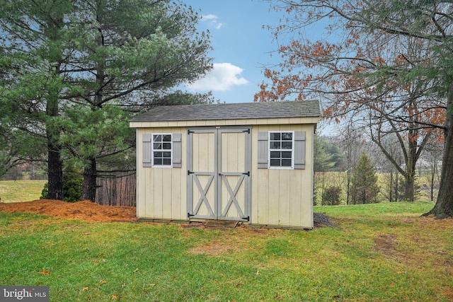 view of outbuilding featuring a yard