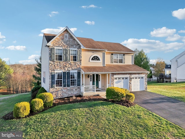 view of front facade featuring a porch, a garage, and a front yard