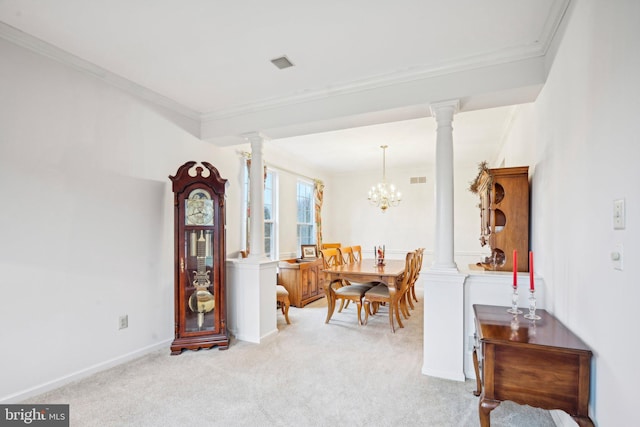 dining space with decorative columns, crown molding, light carpet, and a chandelier