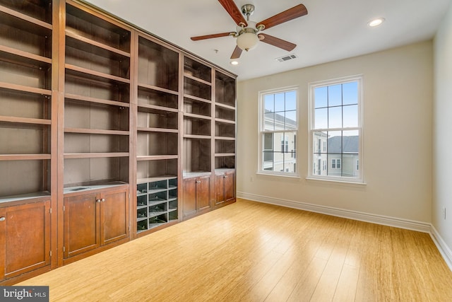 unfurnished living room with baseboards, visible vents, a ceiling fan, light wood-type flooring, and recessed lighting