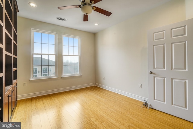 unfurnished room featuring recessed lighting, visible vents, ceiling fan, light wood-type flooring, and baseboards