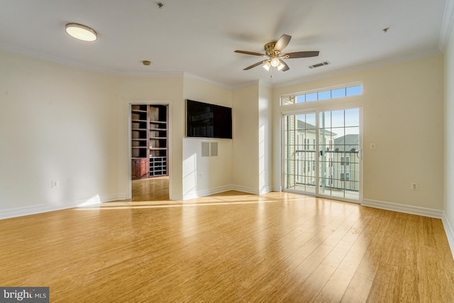 unfurnished room with ceiling fan, light wood finished floors, visible vents, and crown molding