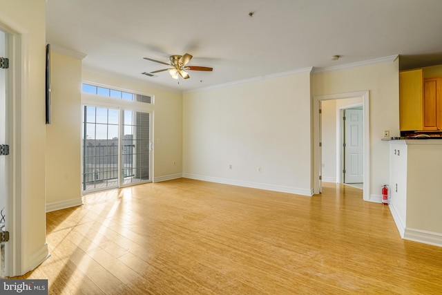 unfurnished living room featuring ornamental molding, light wood-type flooring, ceiling fan, and baseboards