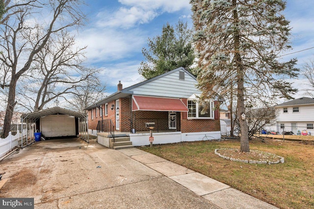 view of front of house with a front lawn and a carport