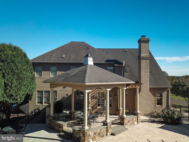 rear view of property featuring a patio