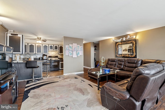 living room with wood-type flooring and ceiling fan