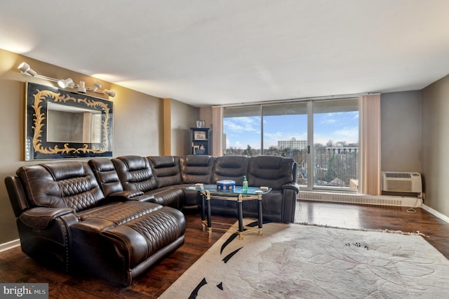 living room with a wall mounted air conditioner and dark wood-type flooring