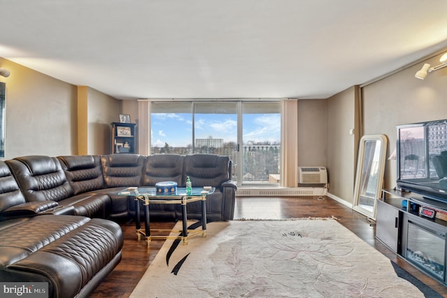 living room with dark hardwood / wood-style flooring, a wall unit AC, and floor to ceiling windows