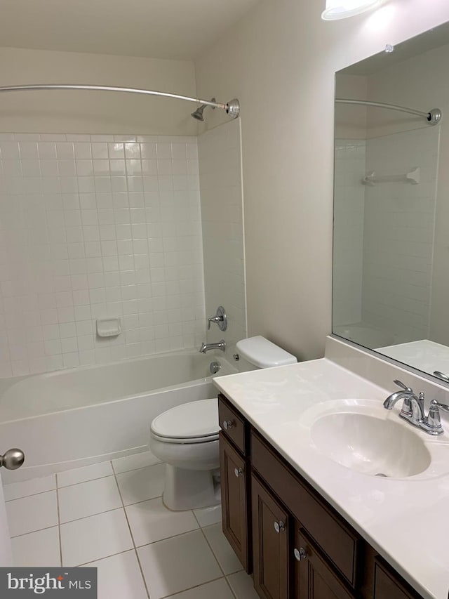 full bathroom with tile patterned floors, vanity, toilet, and tiled shower / bath combo