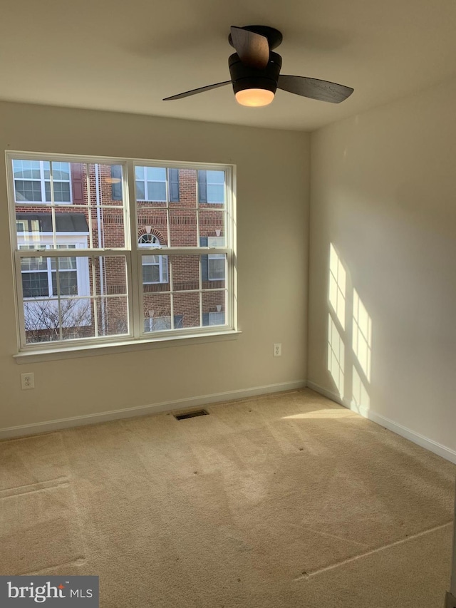 carpeted empty room with ceiling fan