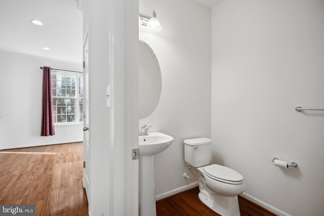 bathroom featuring hardwood / wood-style floors, toilet, and sink