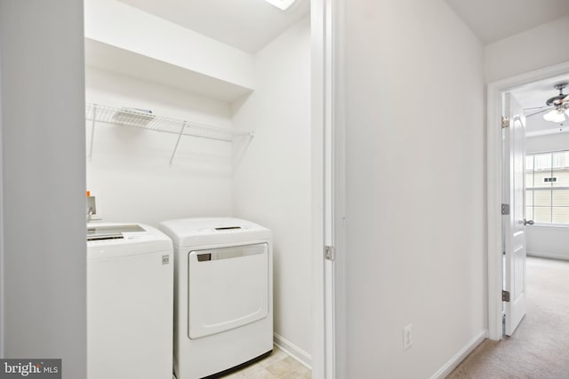 washroom featuring washing machine and clothes dryer, ceiling fan, and light carpet