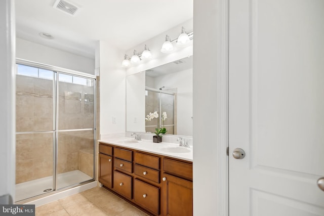 bathroom featuring tile patterned flooring, vanity, and an enclosed shower