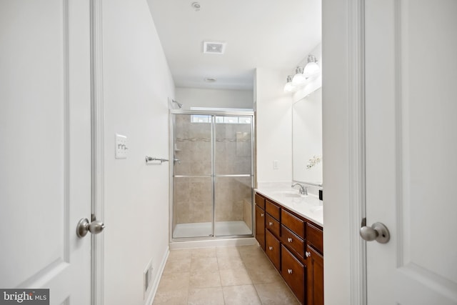 bathroom with vanity, tile patterned floors, and a shower with door