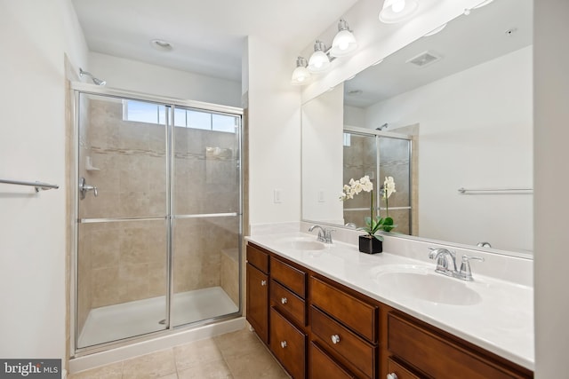 bathroom featuring tile patterned flooring, vanity, and walk in shower