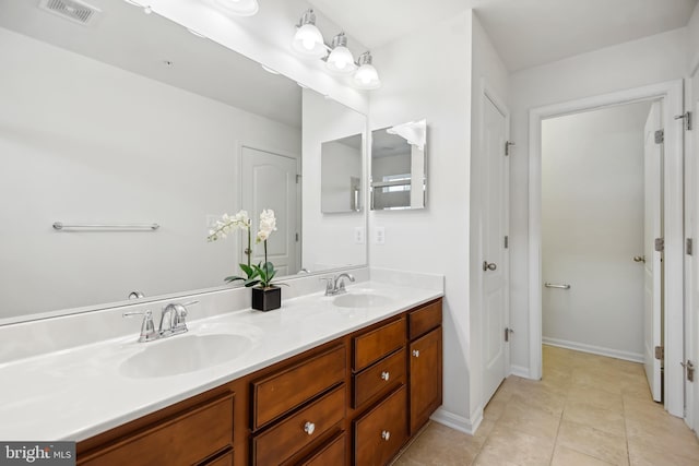 bathroom with tile patterned flooring and vanity