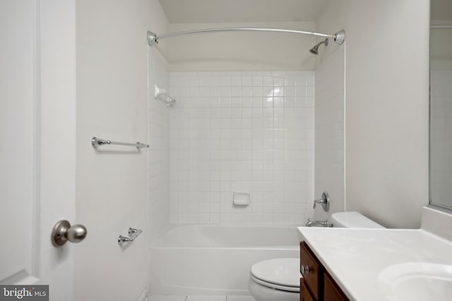 full bathroom featuring vanity, tiled shower / bath combo, and toilet