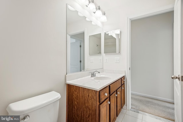 bathroom with tile patterned flooring, vanity, and toilet