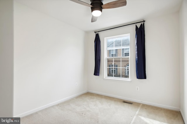 unfurnished room with ceiling fan and light carpet