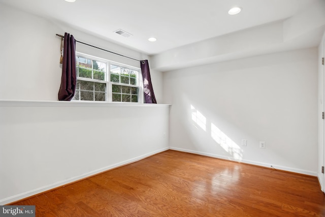 spare room featuring wood-type flooring