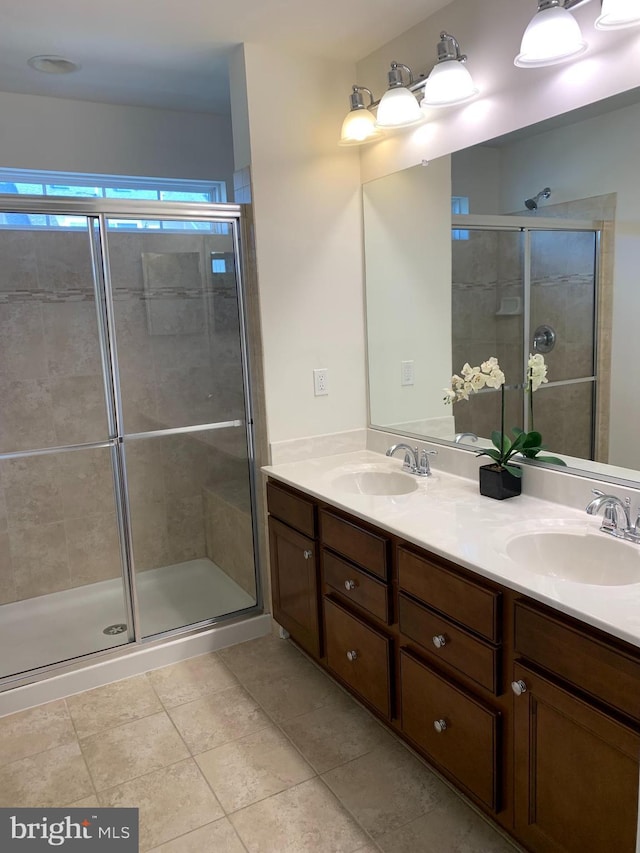 bathroom featuring vanity, tile patterned floors, and a shower with door