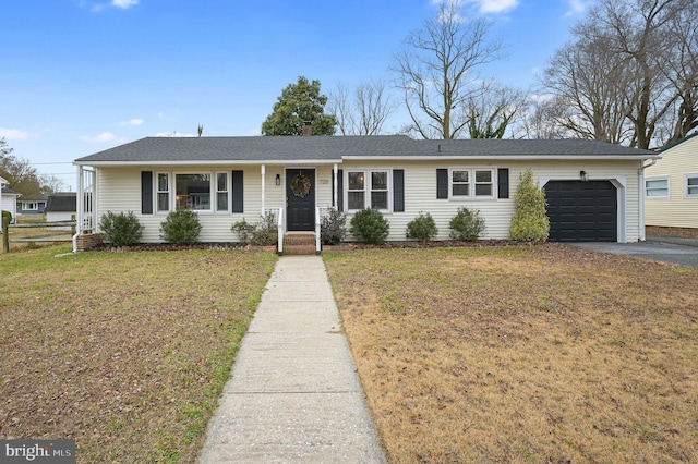 ranch-style home with a front yard and a garage