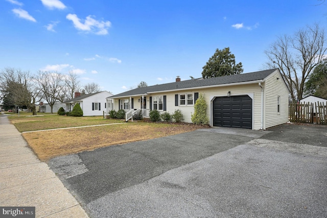 ranch-style house with a porch, a garage, and a front yard