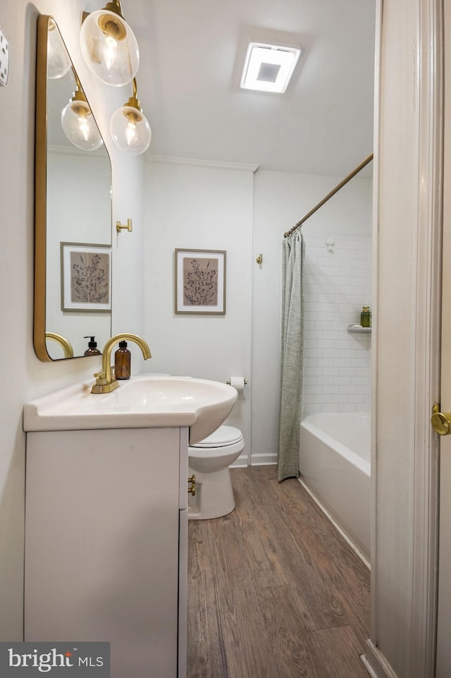 full bathroom with hardwood / wood-style floors, vanity, toilet, and shower / tub combo